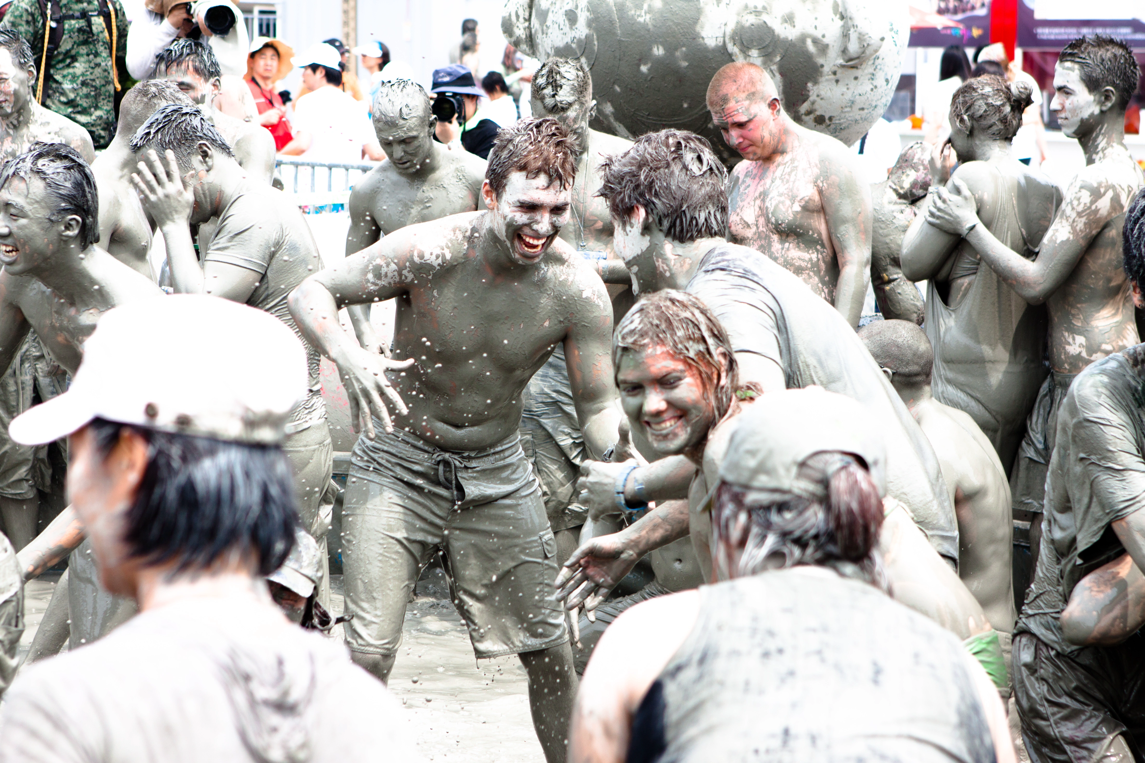 Participants covered in mud during Boryeong Mud Festival in South Korea